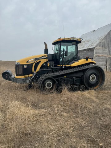 2013 Challenger MT855C tracked tractor with cab and rubber tracks on a farm field.