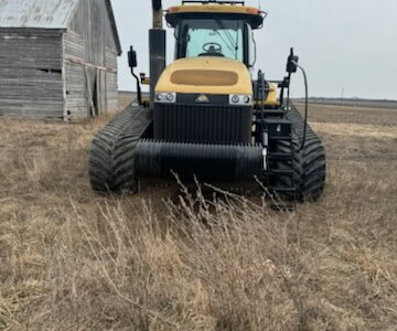 2013 Challenger MT855C crawler tractor with enclosed cab and track system in field.