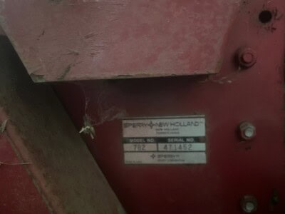 Close-up of New Holland 782 tractor equipment label and controls.