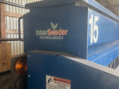 Blue InterSeeder Technologies equipment with warning label and number 15.