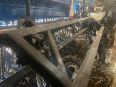 InterSeeder agricultural equipment with blue tank and black frame, used for planting.