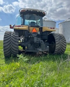 2013 Challenger MT855C agricultural tractor with cab and large tires on green field.