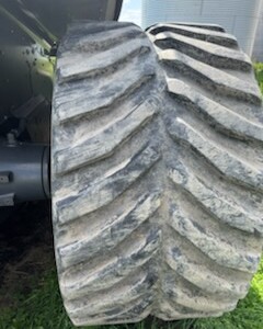 Large tractor tire with deep treads on a Challenger MT855C from 2013.