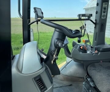 Cabin interior of a 2013 Challenger MT855C tractor with steering wheel and control panel.