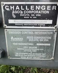 Close-up of Challenger MT855C tractor's metal identification plates showing model and manufacturing details.