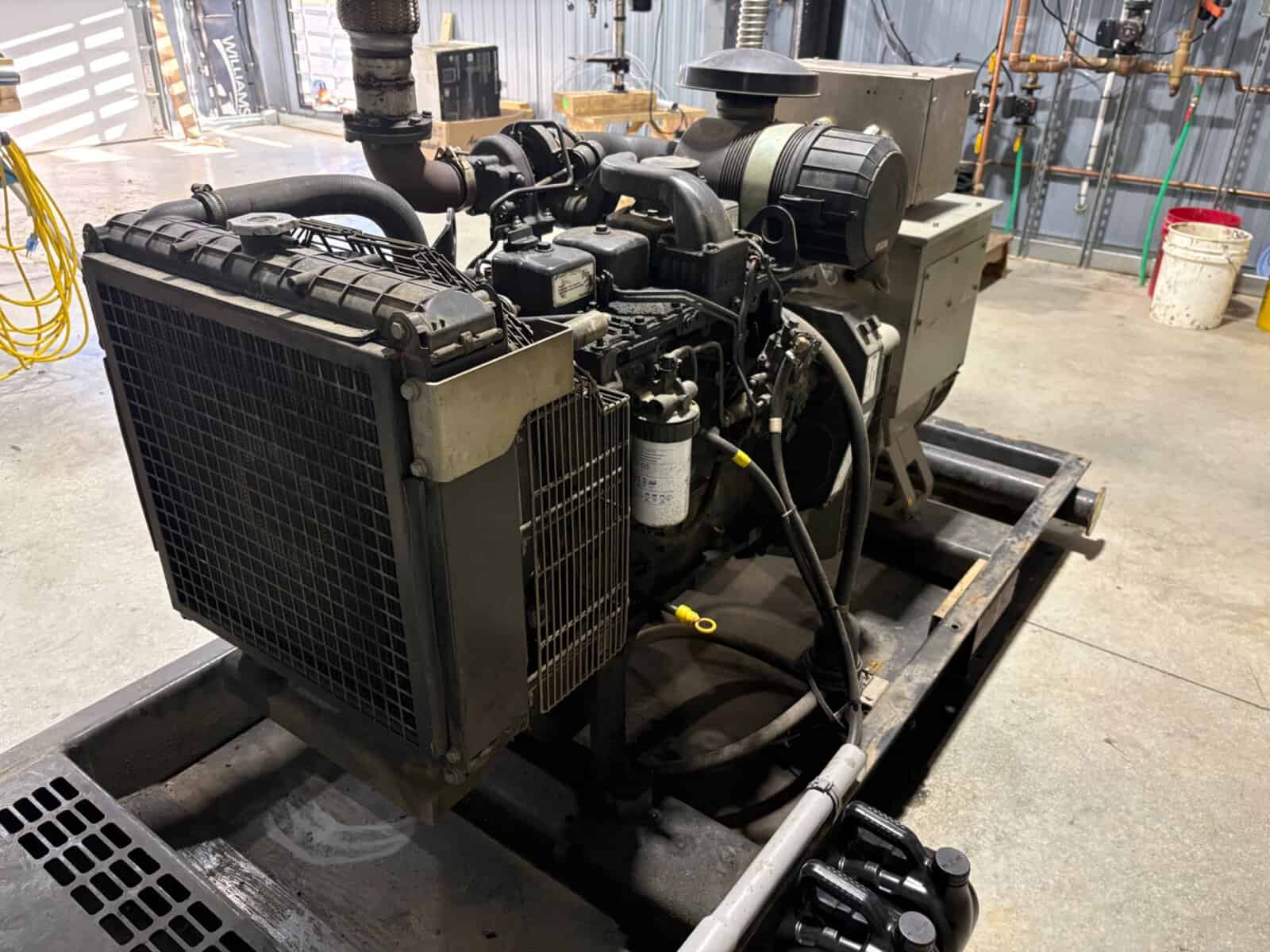 60 kW Diesel Generator Set Equipment 60 kW diesel generator set with radiator and engine components in industrial setting.