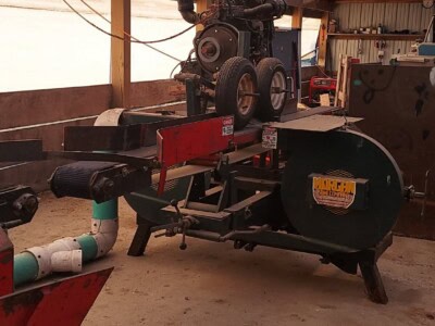 Morgan single head resaw machine with motor and blade assembly in a warehouse setting.