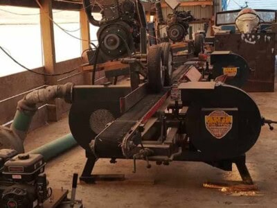 Morgan single head resaw machine with large circular saw and control panel inside warehouse.