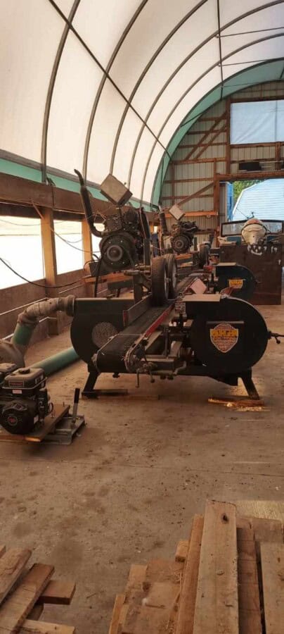 Morgan single head resaw machine with large circular saw and control panel inside warehouse.