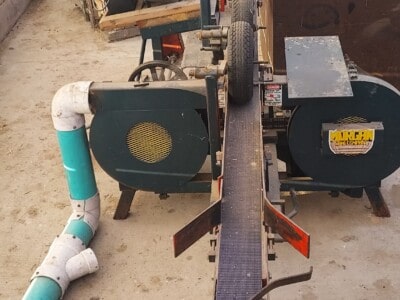 Morgan single head resaws with engine, saw, and control panel in a workshop setting.