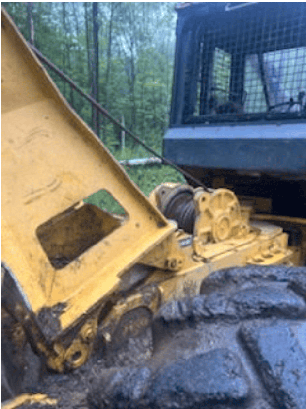 Screenshot 2026-09-09 113537 Yellow bulldozer with enclosed cab and large tracks in a wooded area.