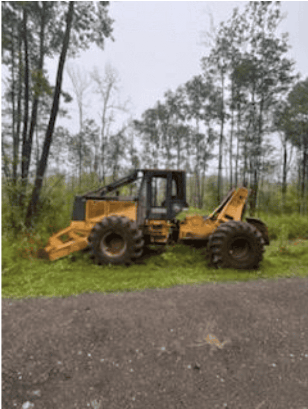 Yellow Caterpillar wheel loader with front bucket attachment on grassy area.