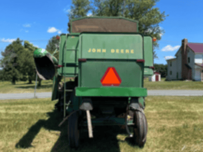 John Deere 6600 combine harvester with green body and yellow logo in a field.