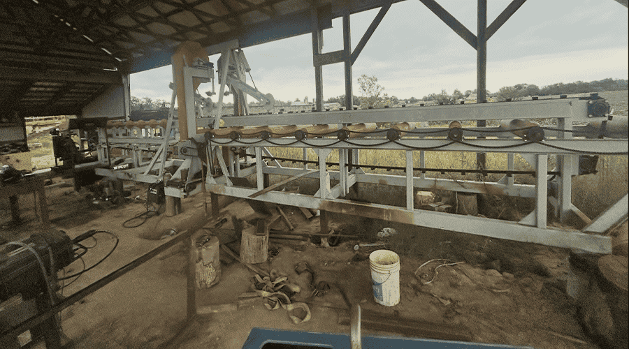 image0 (1) Heavy-duty Sharp Chain Scragg Mill with conveyor system in an open-sided shed.