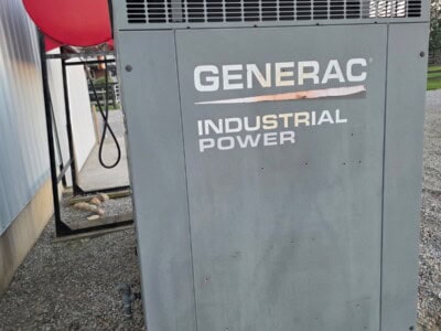 Generac 50 KW propane industrial generator with vented top and gray metal enclosure.