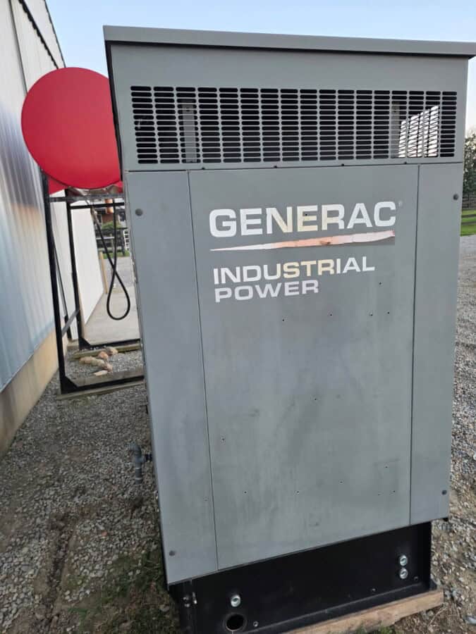 Generac 50 KW propane industrial generator with vented top and gray metal enclosure.