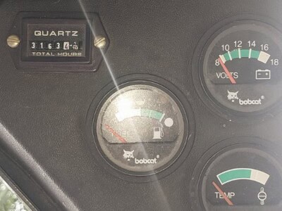 Bobcat equipment hour meter and gauges on dashboard with total hours 3163.