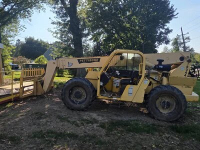 2006 Pettibone T8044 telehandler with extended boom and attachments in outdoor setting.