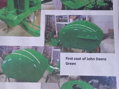 John Deere Green tractor parts and equipment with first coat applied.
