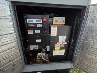 2014 Generac 50 kW propane generator with control panel and fuel system inside an outdoor enclosure.