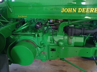 John Deere Rice Special tractor engine with green paint and visible mechanical parts.