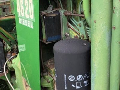 Green John Deere 4620 diesel tractor engine with visible filters and components.