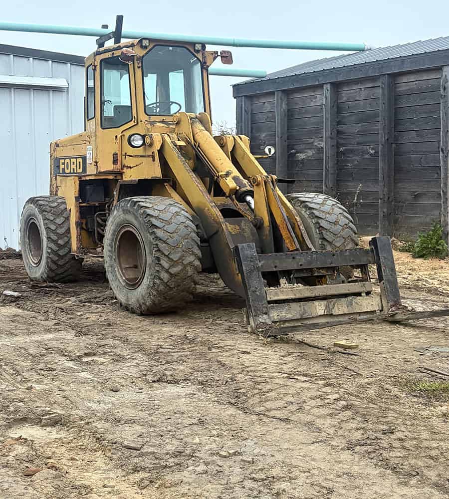 Ford A64 Wheel Loader for Sale Yellow Ford A64 wheel loader with front bucket and enclosed cab, used condition, outdoor setting.