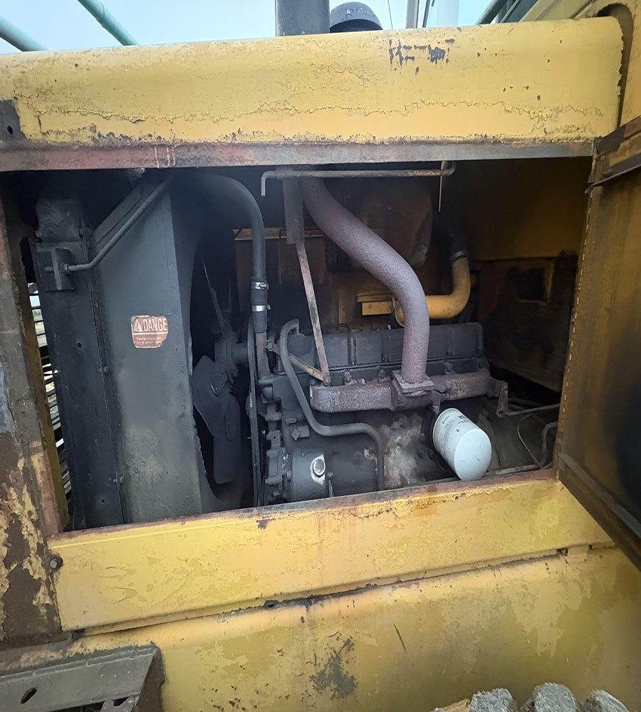 Used Caterpillar D6 Dozer Engine Compartment Caterpillar D6 bulldozer engine with visible hoses and components in yellow machine.