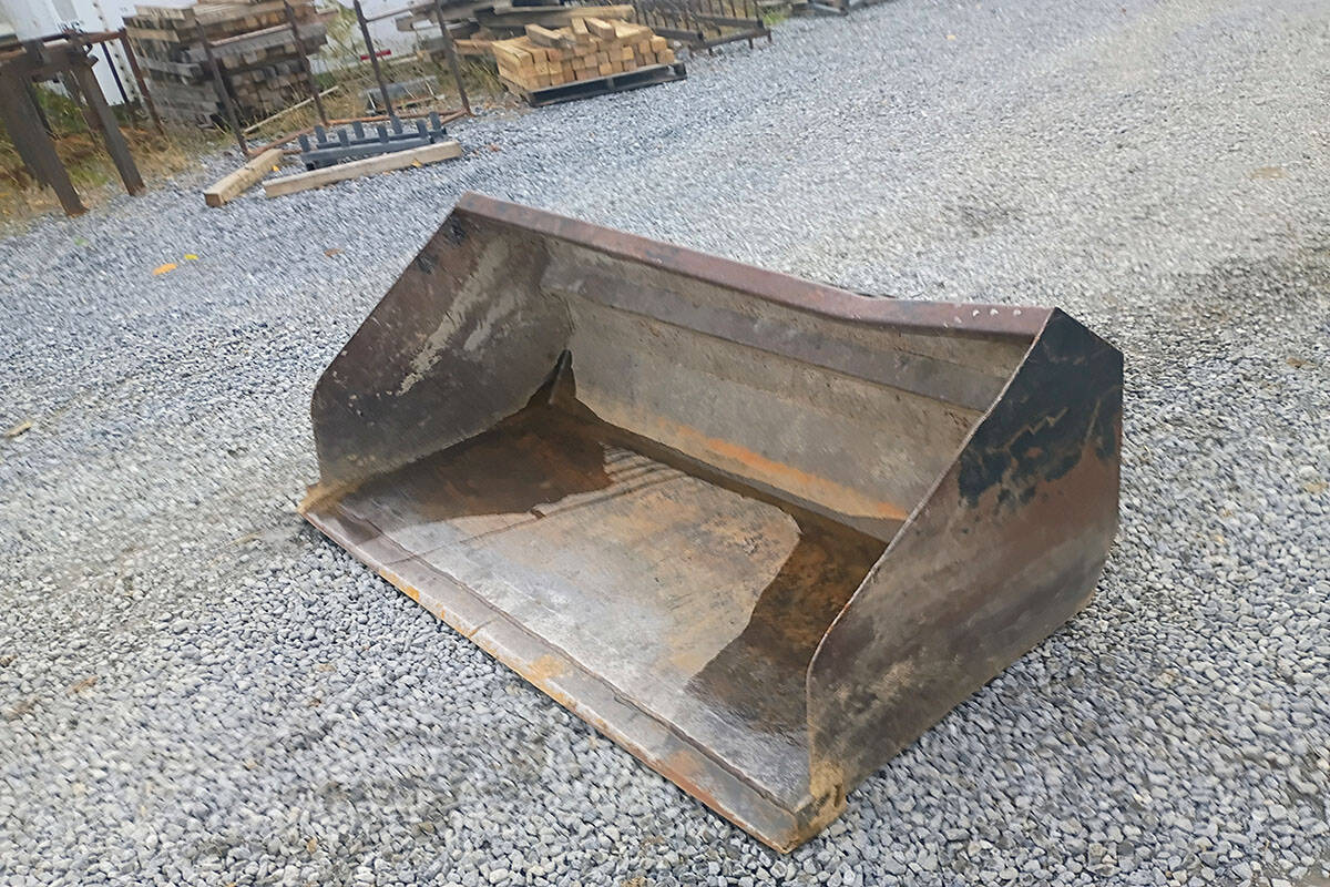 Heavy-duty Excavator Bucket for Construction Large excavator bucket with wear edges and rust, suitable for heavy construction work.
