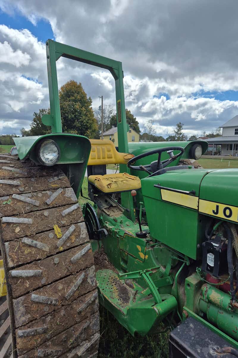 John Deere 5075E Tractor with Loader John Deere 5075E tractor with front loader and large rear tires in an outdoor setting.