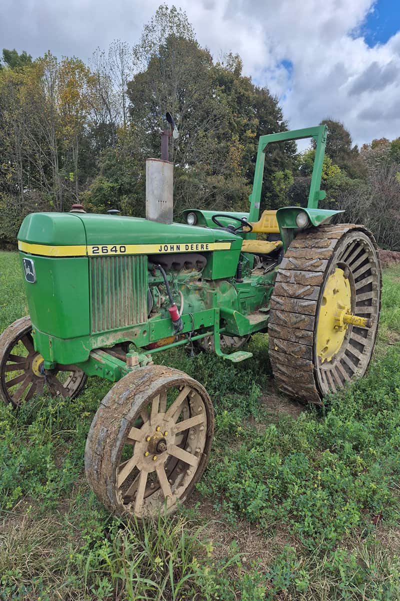 John Deere 2640 Tractor for Sale Green John Deere 2640 tractor with large rear tires and smaller front tires on grassy field.