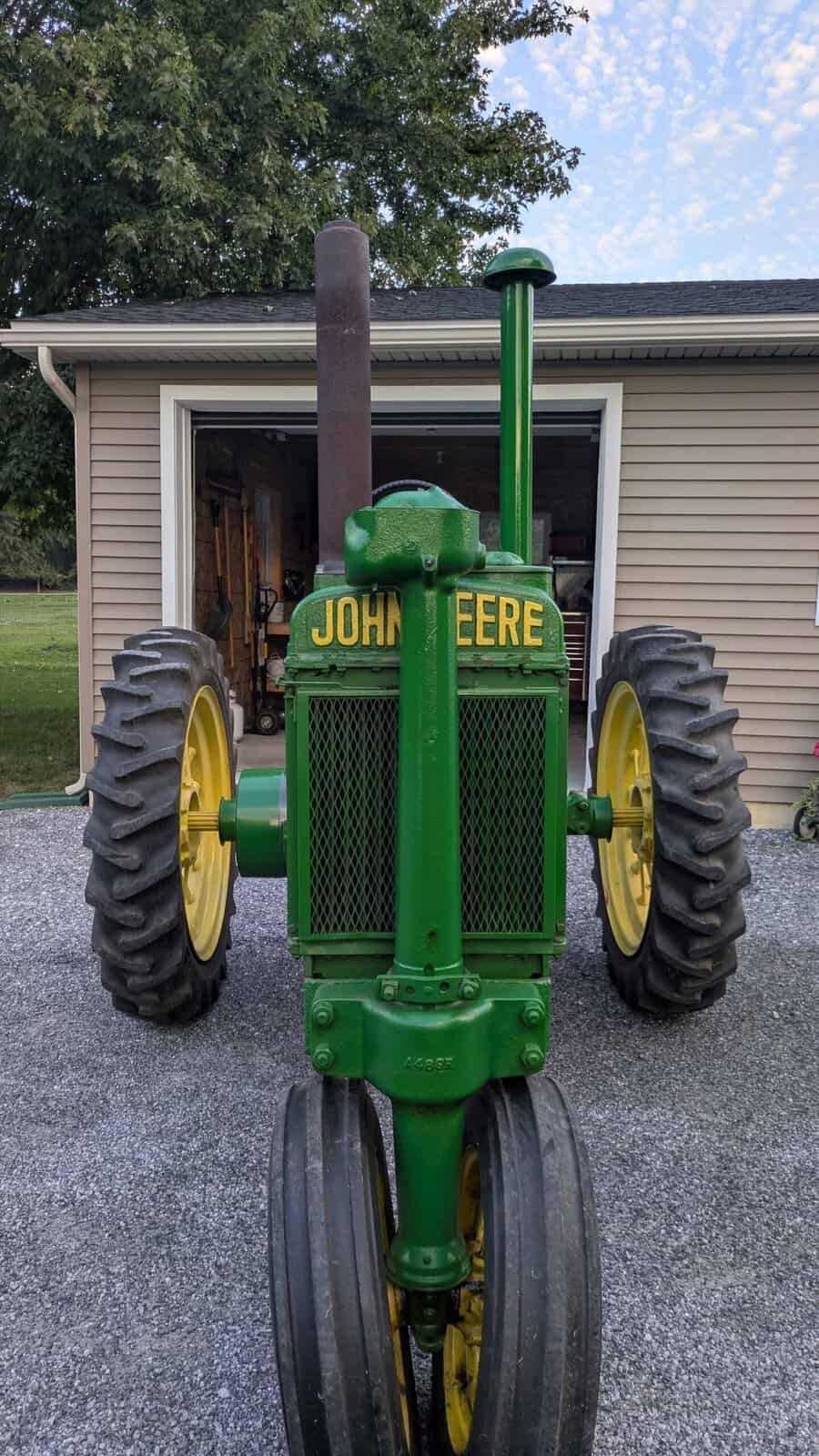 4454 (2) Vintage 1938 John Deere A tractor with green body and yellow wheels, front view.