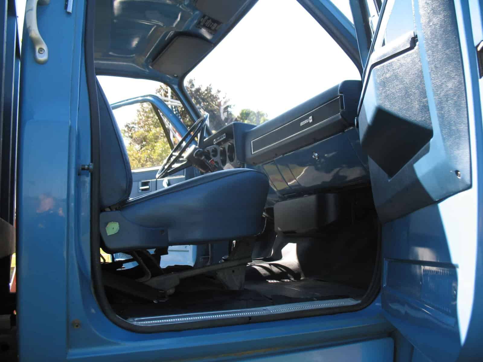 1985 GMC C7000 Grain Truck Cab Interior 1985 GMC C7000 grain truck cab interior showing blue upholstery and dashboard.