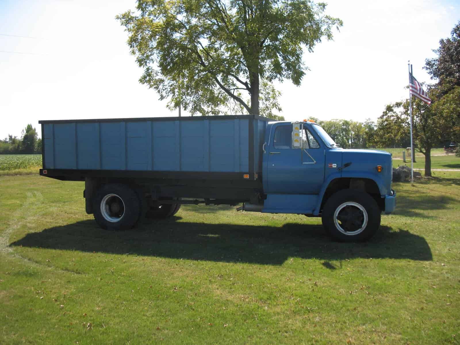 1985 GMC C7000 Dump Truck for Sale 1985 GMC C7000 blue dump truck on grass with cargo bed.