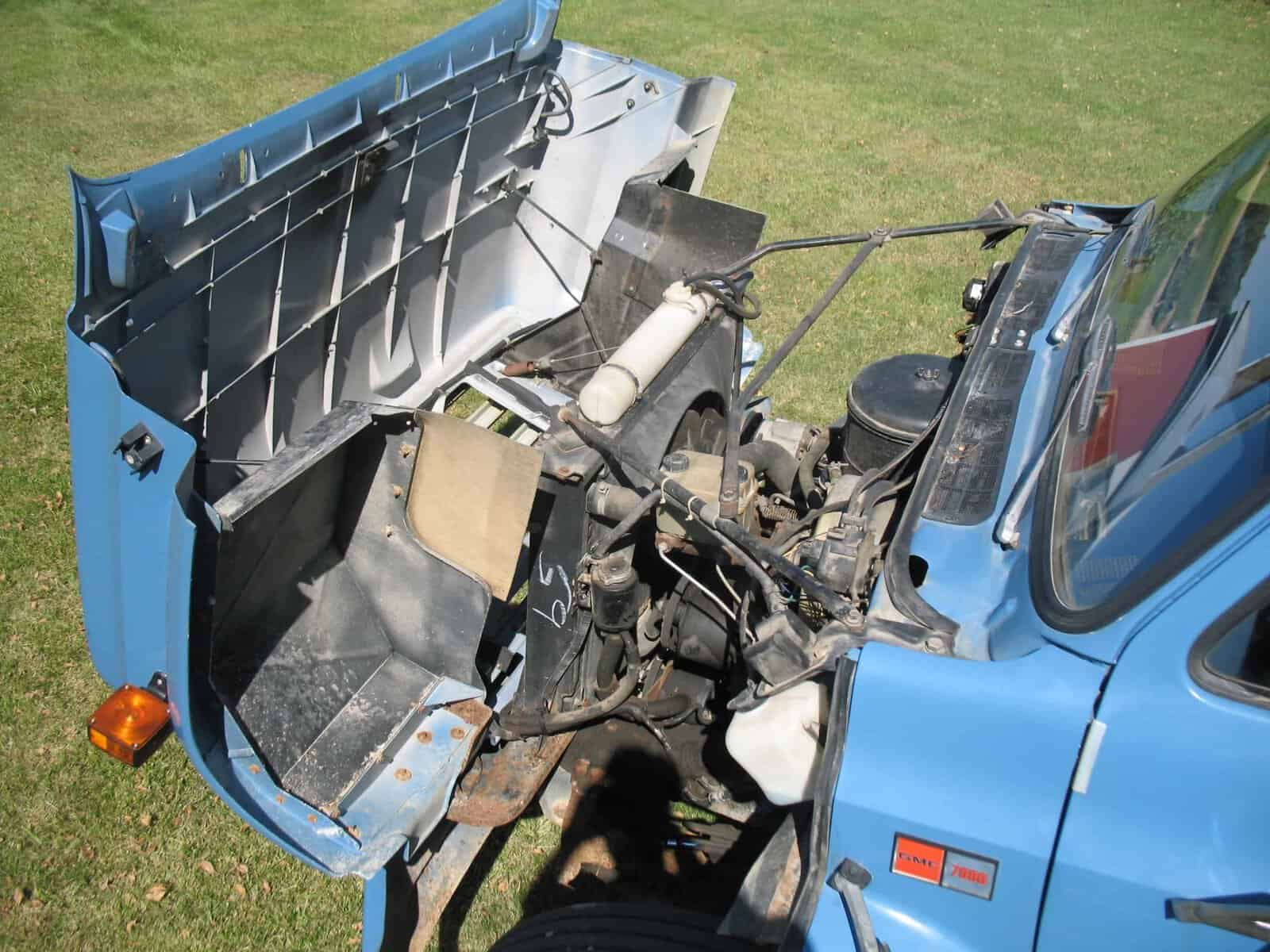 1985 GMC C7000 Grain Truck engine area 1985 GMC C7000 grain truck engine compartment and cab with hood open.