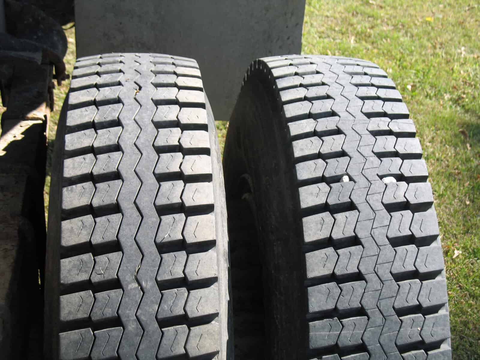 GMC C7000 Grain Truck Tires on Dual Rear Axle Two heavy-duty truck tires with deep treads on dual rear axle.