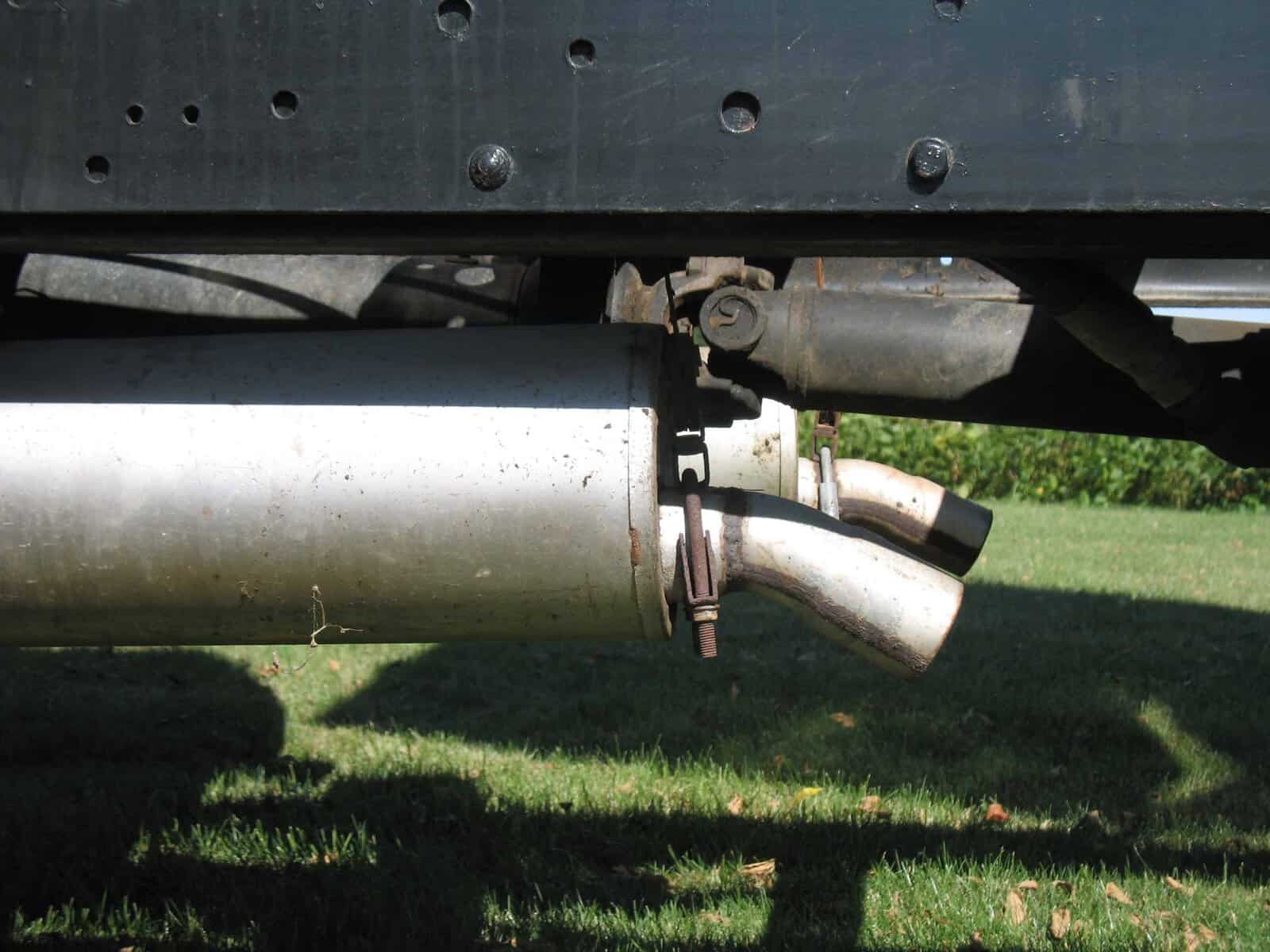 1985 GMC C7000 exhaust and hitch detail Rear exhaust pipe and hitch on 1985 GMC C7000 grain truck with metal chassis.