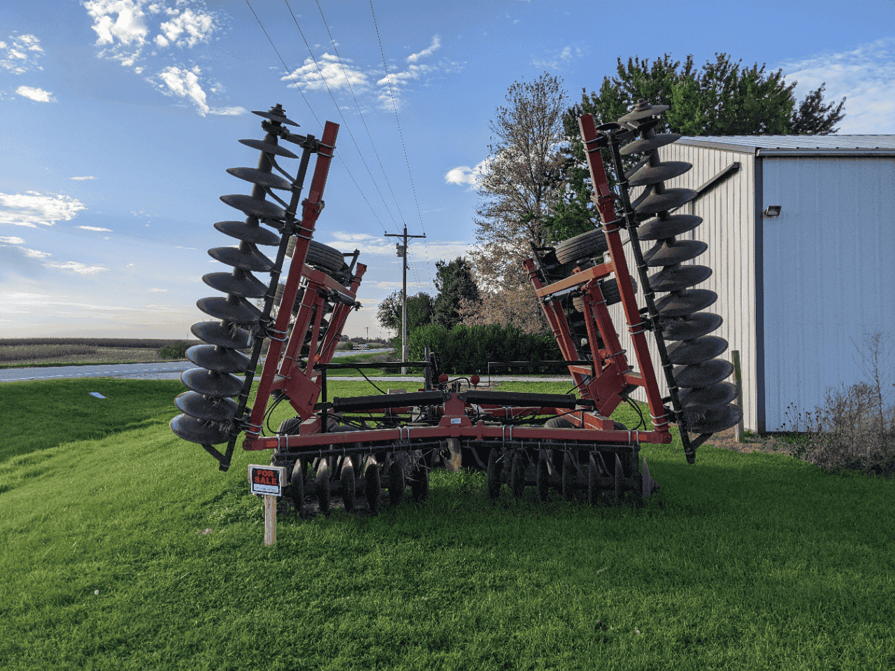 Versatile TD500 Field Seed Drill Versatile TD500 field seed drill with disc harrows and storage frame on lawn.