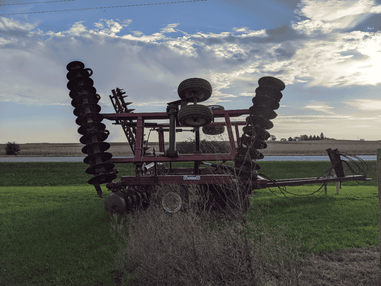 Versatile TD500 Disk Harrow in field Versatile TD500 disk harrow with multiple disc gangs in a rural field.