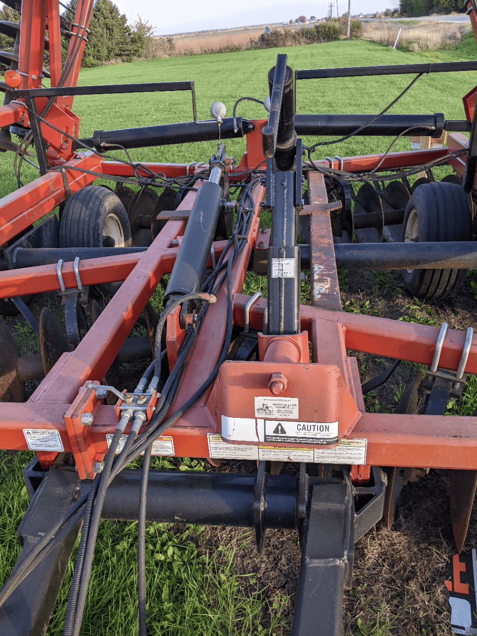 Versatile TD500 Wheel Loader? Red agricultural equipment with hydraulic hoses and black bars on a farm field.