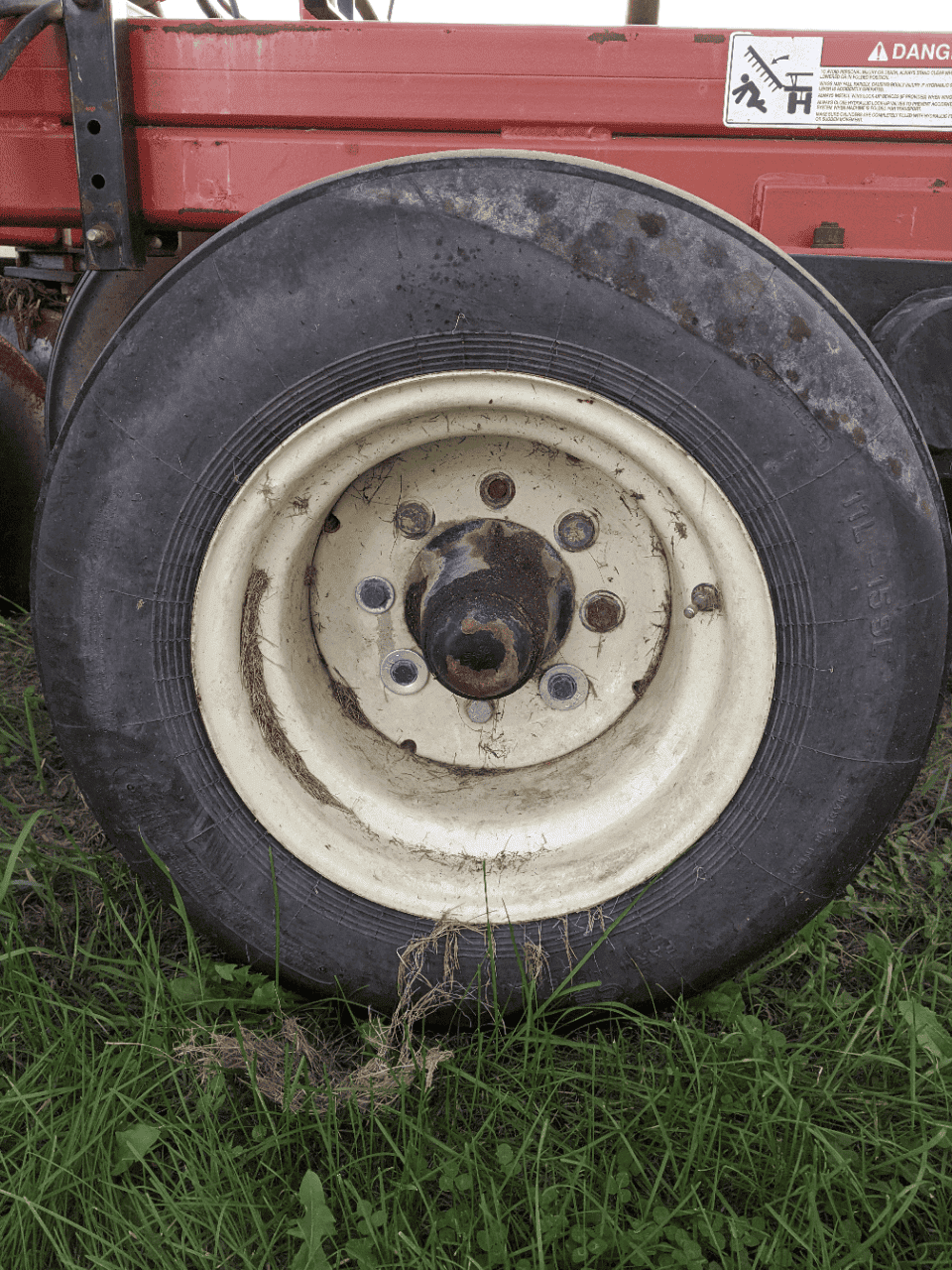 TD500 wheel and tire detail Versatile TD500 tractor wheel with large pneumatic tire and white rim.