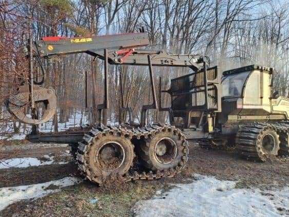 RAW_Logset 2 2017 Logset forwarder with tracked wheels and cab in a wooded area.