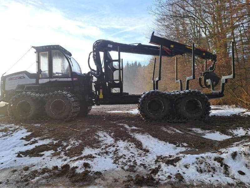 RAW_Logset 4 2017 Logset forwarder with tracked wheels and hydraulic arm in snowy forest setting.