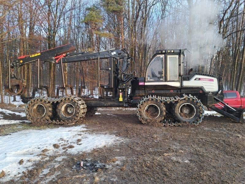 2017 Logset forwarder with tracked wheels and cab in a wooded area with snow.