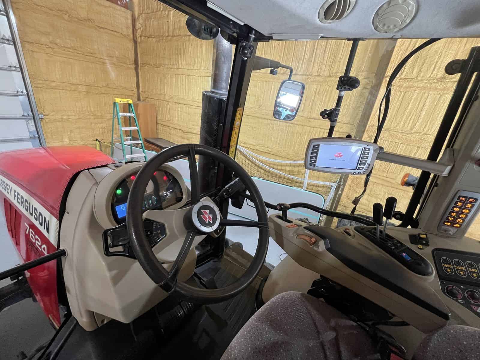 2012 Massey Ferguson 7624 Tractor Interior Interior view of a 2012 Massey Ferguson 7624 tractor with dashboard and steering wheel.
