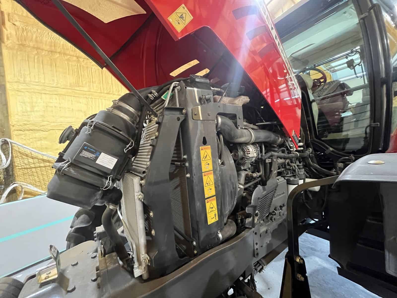 c9bafdb8-bcbe-4ef6-b8ff-81ef91c5792b (1) 2012 Massey Ferguson 7624 tractor engine with open hood showing radiator and engine components.