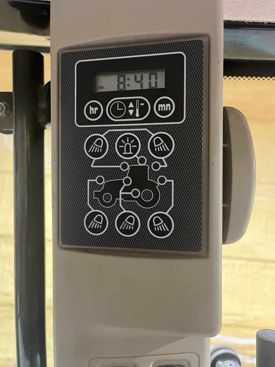 Agricultural Equipment Control Panel 2012 Massey Ferguson 76 Control panel with digital clock and various control icons on Massey Ferguson 7624 tractor.