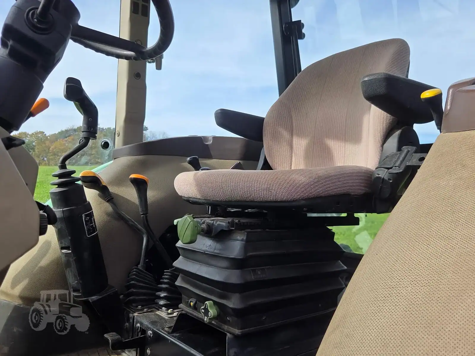 img (11) 2010 John Deere 5101E tractor cab interior with seat and controls.