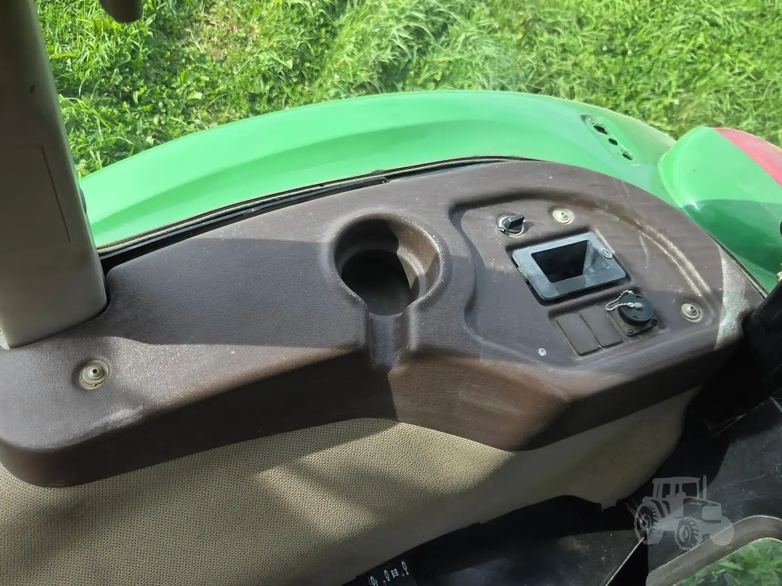 img (18) Close-up of tractor dashboard with digital display and control buttons.