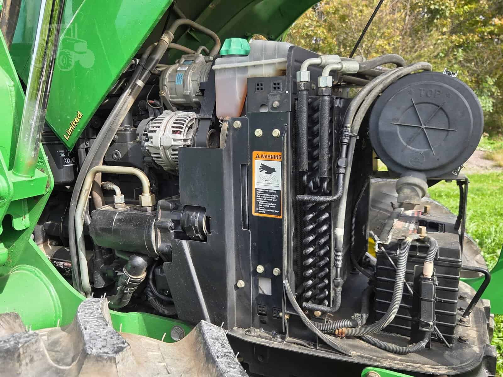 img (2) Close-up of engine and radiator of 2010 John Deere 5101E tractor.